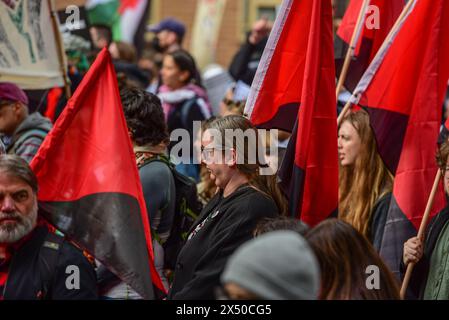 Melbourne, Australia. 05th May, 2024. Protesters with Anarchists flags march during the May Day rally. The annual rally in Australia takes place on the first Sunday of May. May Day or International Workers Day is celebrated on the 1st of May and unites together Union movements, with left wing political parties. Credit: SOPA Images Limited/Alamy Live News Stock Photo