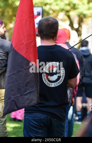 Melbourne, Australia. 05th May, 2024. Man hold an Anarchists flag during the May Day rally. The annual rally in Australia takes place on the first Sunday of May. May Day or International Workers Day is celebrated on the 1st of May and unites together Union movements, with left wing political parties. Credit: SOPA Images Limited/Alamy Live News Stock Photo