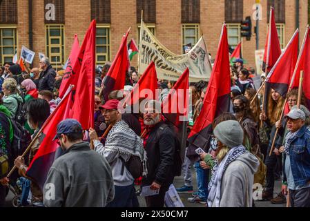 Melbourne, Australia. 05th May, 2024. Protesters with Anarchists flags march during the May Day rally. The annual rally in Australia takes place on the first Sunday of May. May Day or International Workers Day is celebrated on the 1st of May and unites together Union movements, with left wing political parties. Credit: SOPA Images Limited/Alamy Live News Stock Photo