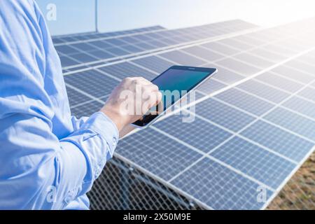 Close-up of a engineer checking solar panel setup. Using smart app in tablet Stock Photo