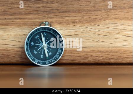 Compass on wooden background with copy space using as direction Stock Photo