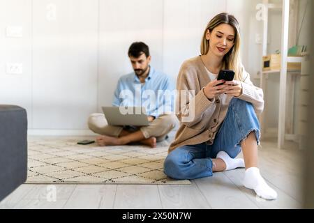 Freelancing couple working together at digital devices in home office. Social media people concept. Stock Photo