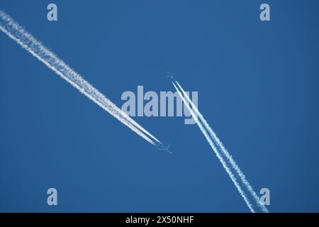 two parallel airplane tracks in the blue sky, contrails Stock Photo - Alamy