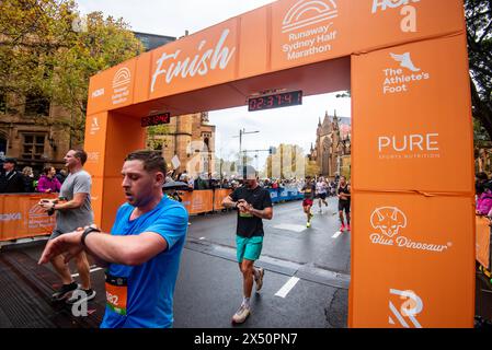 People cross the finish line during the annual 17th Street High Heel ...