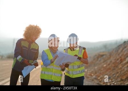 A team of engineers and workers oversees a wind turbine project at a modern wind farm, working together to ensure the efficient generation of Stock Photo