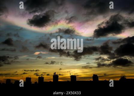 Nacreous clouds also known as Rainbow clouds or Mother-of-Pearl clouds - seen above residential rooftops in Tynemouth, England Stock Photo