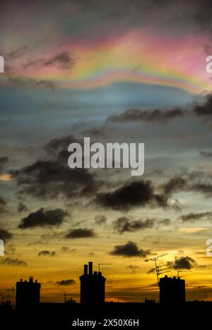 Nacreous clouds also known as Rainbow clouds or Mother-of-Pearl clouds - seen above residential rooftops in Tynemouth, England Stock Photo