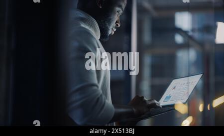 Handsome black entrepreneur working on laptop and taking notes Stock ...