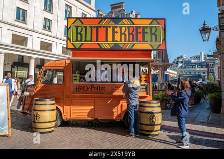 London, UK - 16 April 2022: Orange food and drink truck selling Butterbeer, in Covent Garden, London. This drink was make famous and popular by the Ha Stock Photo