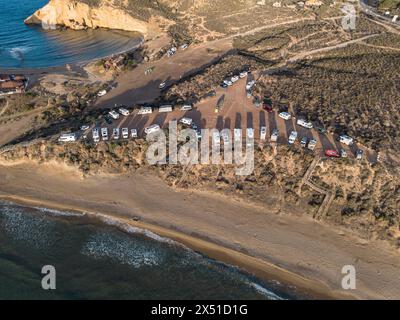 Aguilas, Spain; May 1st 2024: Motor homes and camper vans parked at Playa de la Carolina beach in Cuatro Calas, Aguilas, Murcia Stock Photo