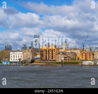 St John's Wharf residential area near the Canary Wharf district along the River Thames, formerly a storage area with traditional riverside warehouses. Stock Photo