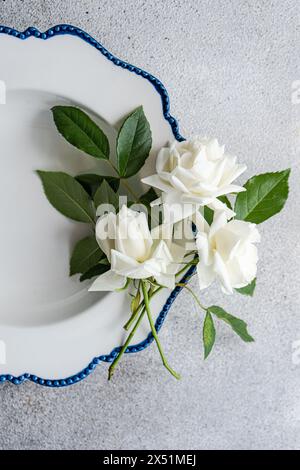 Minimalistic table setting with white roses Stock Photo