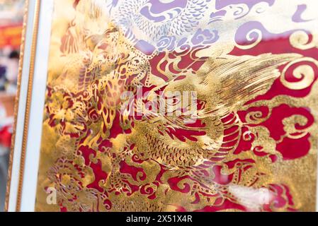 Rachaburi,Thailand - 4 April, 2024: Paper art cut wih golden dragon pattern show and sale at HUAI KRABOK Street MARKET Stock Photo