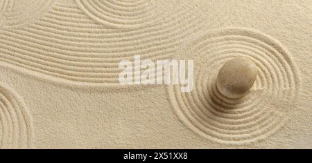 Zen garden with the sand pattern and a single stone Stock Photo