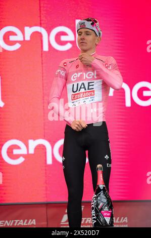 Fossano, Italy. May 6th, 2024. The Slovenian cyclist Tadej Pogačar, of the UAE Team Emirates team, obtains the pink jersey at the third stage of the Giro d'Italia arriving in Fossano. Here he is portrayed on stage celebrating the victory. Credit: Luca Prestia / Alamy Live News Stock Photo