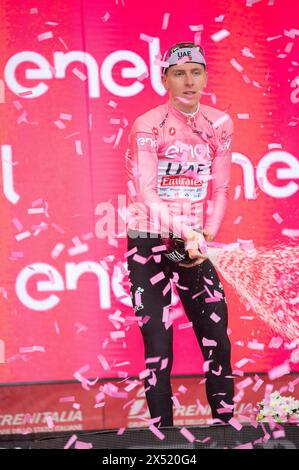 Fossano, Italy. May 6th, 2024. The Slovenian cyclist Tadej Pogačar, of the UAE Team Emirates team, obtains the pink jersey at the third stage of the Giro d'Italia arriving in Fossano. Here he is portrayed on stage celebrating the victory. Credit: Luca Prestia / Alamy Live News Stock Photo