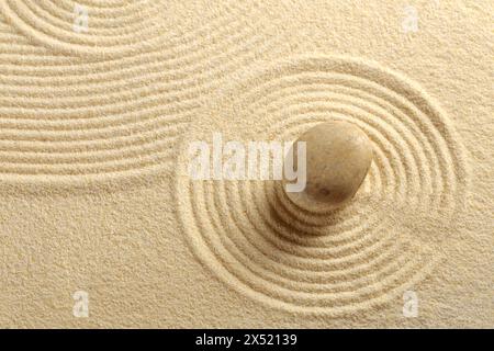 Zen garden with the sand pattern and a single stone Stock Photo