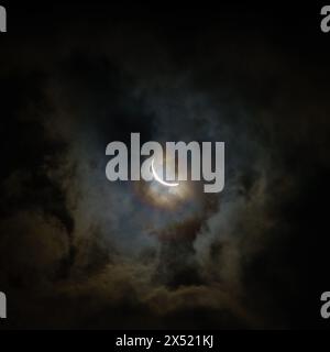 Solar eclipse on April 8, 2024 as seen with partial cloud cover in Central Kentucky Stock Photo