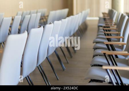conference hall with row upon row of chairs Stock Photo