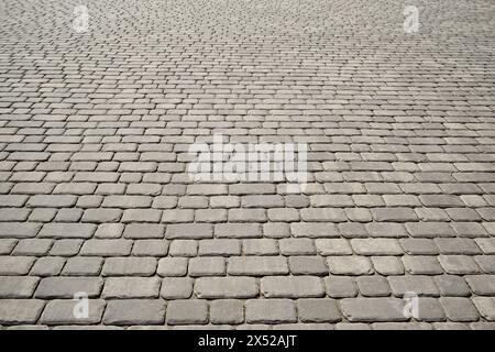 Stone pavement texture in perspective. Abstract background of old cobblestone pavement closeup. Stock Photo