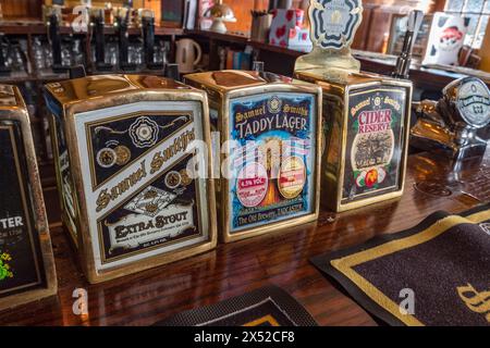 Pump heads for Samuel Smith's Brewery beers on the bar in The Angel public house on Bermondsey Wall East, beside the River Thames, London SE16 4NB Stock Photo