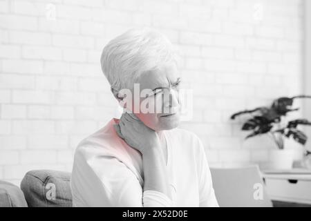 Mature woman suffering from backache at home Stock Photo