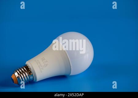 Energy-saving LED light bulb on a blue background Stock Photo