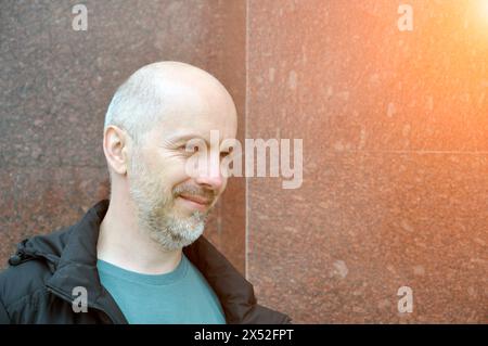 Close-up portrait of a smiling unshaven village guy in dirty clothes. Stock Photo