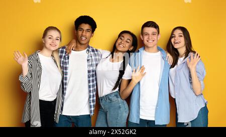 Group of Multiethnic Teenagers Standing Together, Waving at Camera Stock Photo
