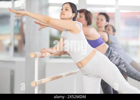 Group of women beginners practicing at ballet barre Stock Photo