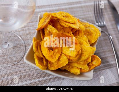 There is appetizer for low alcohol beverage - fried plantains chips Stock Photo