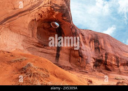 Big Hogan Arch in Monument Valley Arizona lies in a remote area of the park and is unique due to its eroded sandstone on the ceiling of the arch, maki Stock Photo