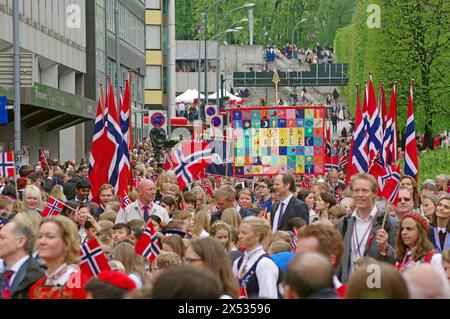People in traditional costumes waving flags on the streets, folklore, bank holidays 17 May, Norwegian flag, Oslo, Norway Stock Photo