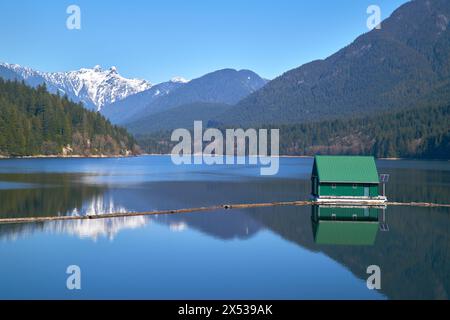 Capilano Lake Mountain Reflection North Vancouver. The view of the Lions high over the Capilano Lake Reservoir in Capilano River Regional Park, North Stock Photo