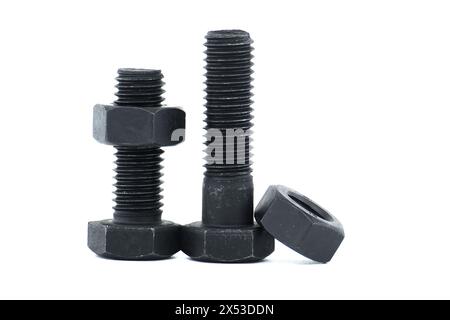 Orderly arrangement of dark-colored metal of hex bolts and nuts include long and shorter parts, placed against a clean, white background Stock Photo