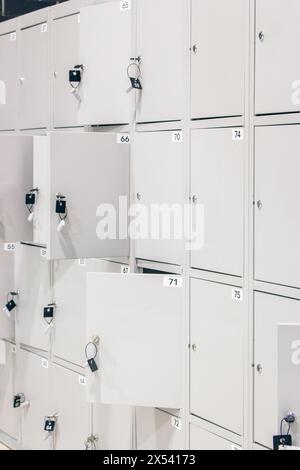 Metal luggage storage at shopping mall. Safe lockers in public place. Locker room with  numbered boxes. Private safety in supermarket. Secure in gym. Stock Photo