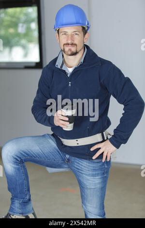 portrait of male builder holding coffee cup Stock Photo