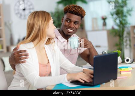 happy couple check paper bills paying online Stock Photo