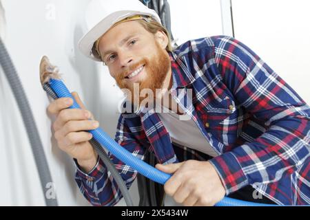 plumber is working on wall Stock Photo