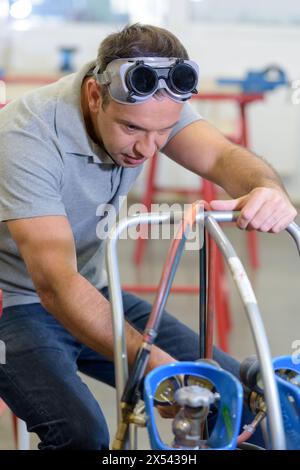 man wearing safety glasses before soldering Stock Photo