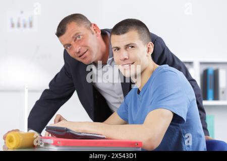 male teacher helping student and giving support Stock Photo