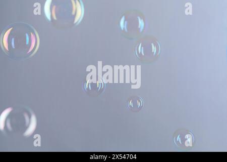 Beautiful transparent soap bubbles on gray background Stock Photo