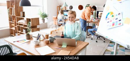 Female graphic designer working at table in office Stock Photo
