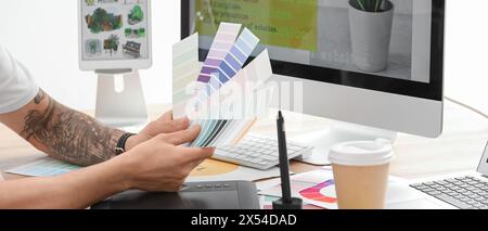 Male graphic designer choosing colors in office Stock Photo