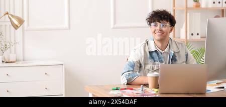Male graphic designer working at table in office Stock Photo