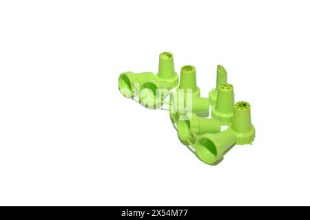 Replaceable nozzles made of plastic, green, lie on a white background. Stock Photo