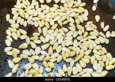 Stone pine, Italian Stone pine, Umbrella Pine (Pinus pinea), Pine nuts are roasted in the pan Stock Photo
