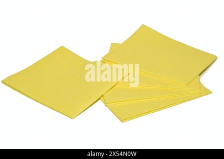 Yellow viscose napkins for removing dust and dirt lie on a white background. Stock Photo