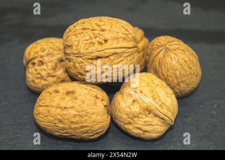 walnut (Juglans regia), Walnuts on a black background Stock Photo