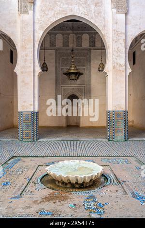 Tranquil courtyard featuring a traditional fountain with intricate tile work in Fez, Morocco. Stock Photo